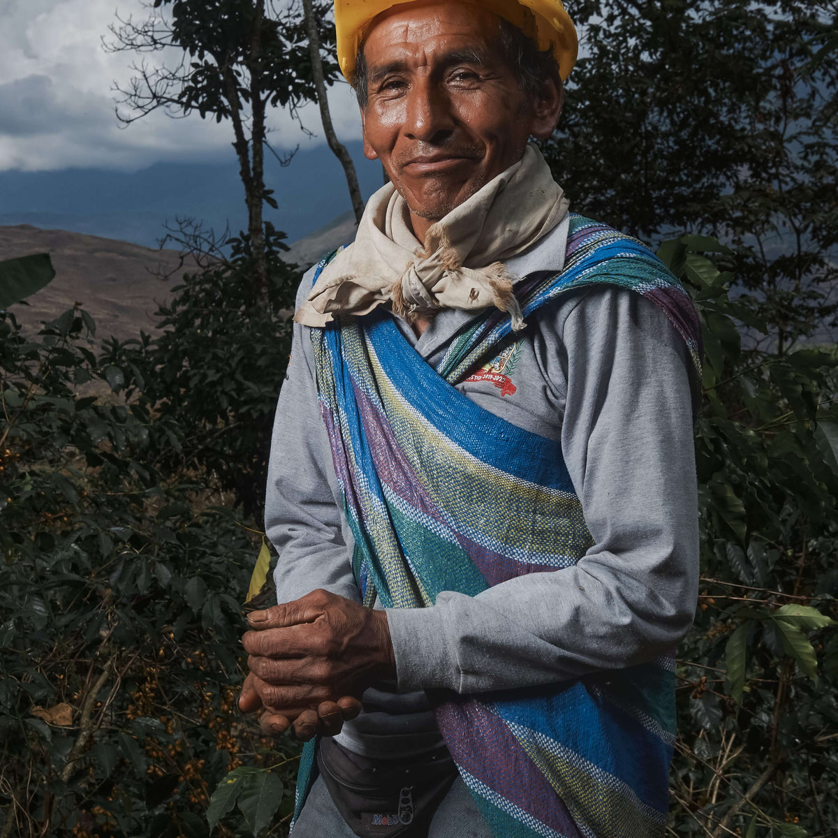 Man standing outdoors with mountains in the background