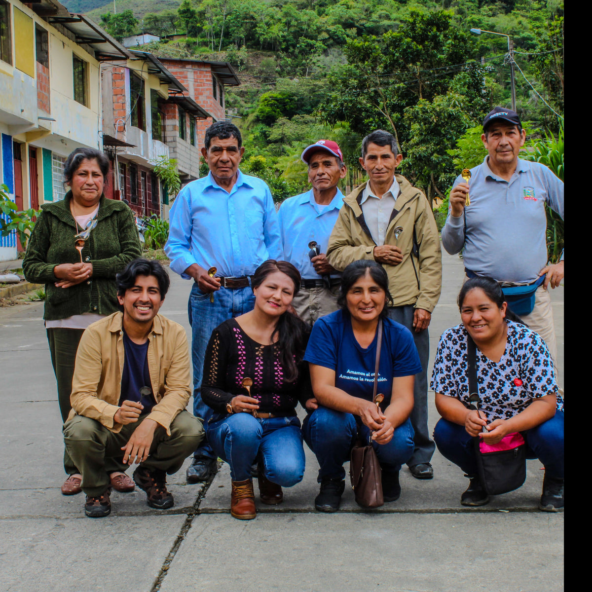 Group of people posing outdoors with a rural background